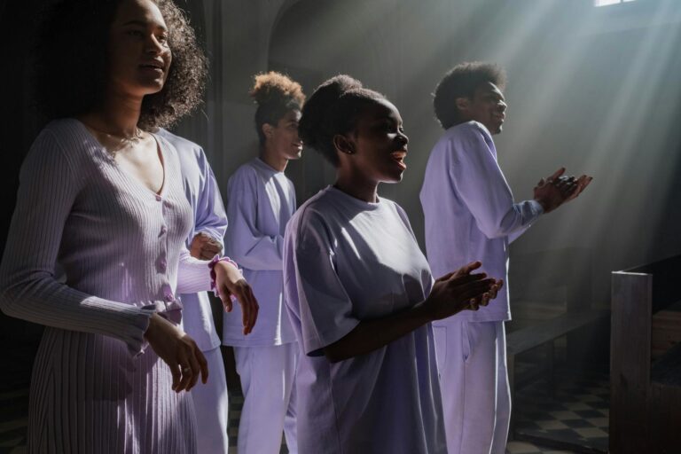 A group of African American singers performing in a sunlit church interior, creating a spiritual atmosphere.